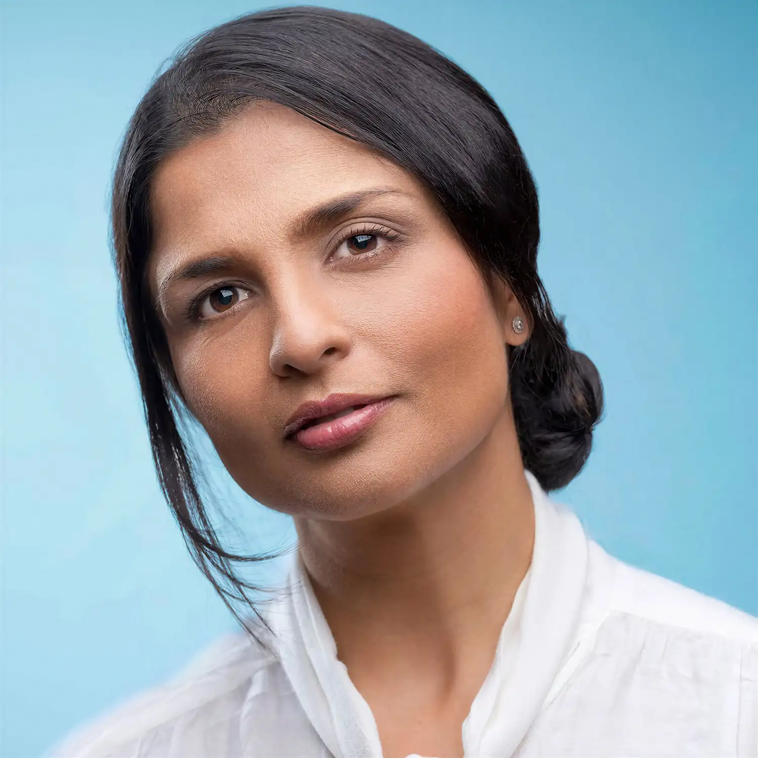 Colour portrait of a professional woman against a blue background
