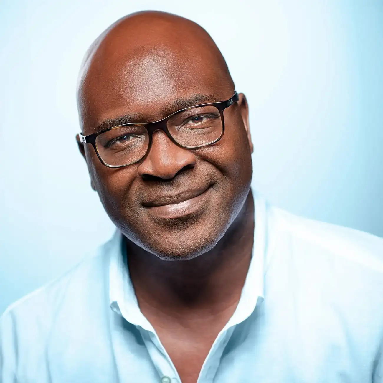 Colour portrait of a smiling man in glasses